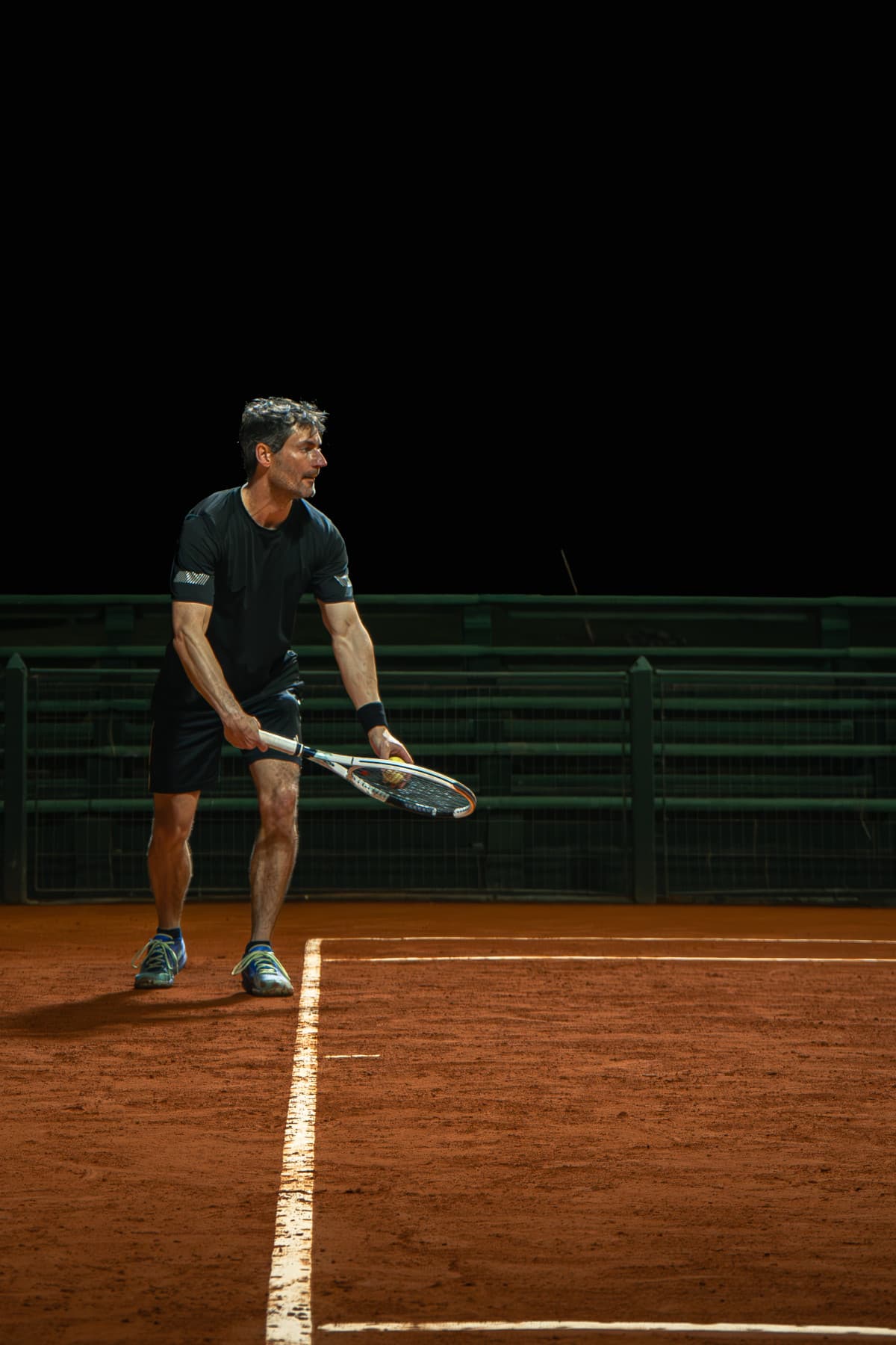 Tennis player serving on clay court